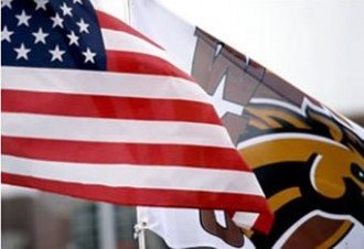 American flag and WMU flag flying on campus