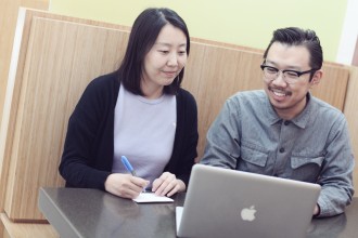 qi and qian working on a laptop