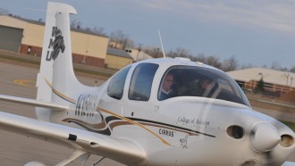 Two male pilot from the front view running a small airplane from.