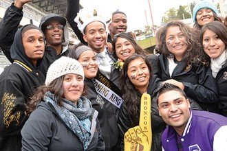 Photo of WMU Homecoming King with students.
