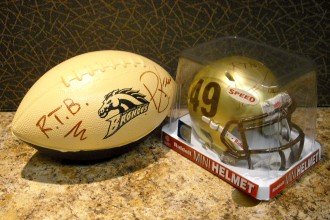 Photo of a WMU Bronco football and mini helmet.