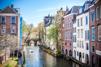 Photo of a long canal in Utrecht, the Netherlands, flanked on both sides by four-story buildings.