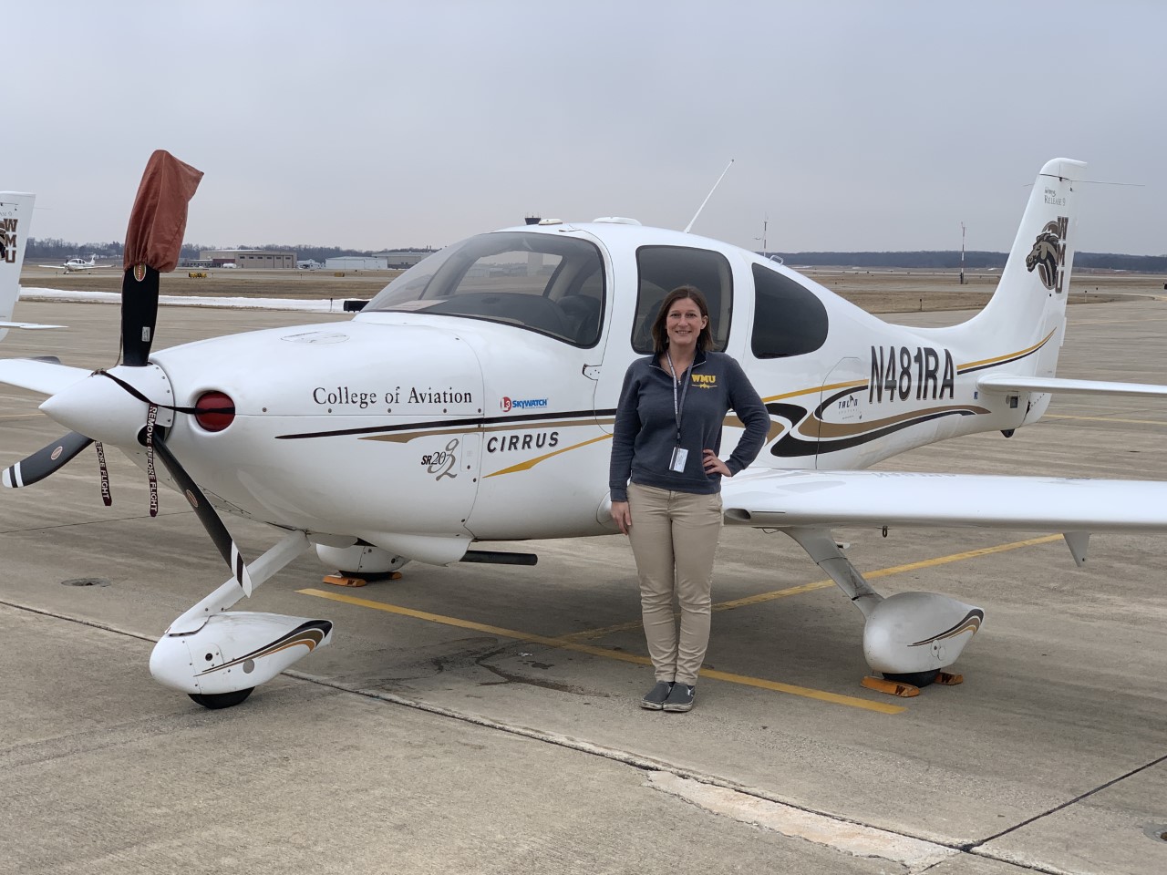Ashley next to one of Western's Cirrus SR20 aircraft. 