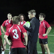 Thomas Lyons on rugby field with players