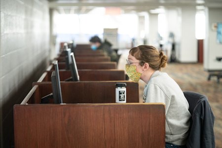 Student sitting at computer workstation in Waldo Library.