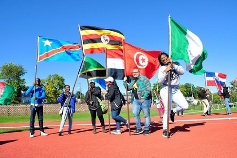 Parade of Nations participants holding flags.