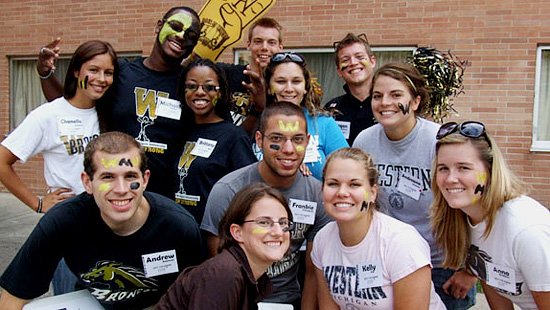 Photo of a group of students in WMU gear outside of a residence hall