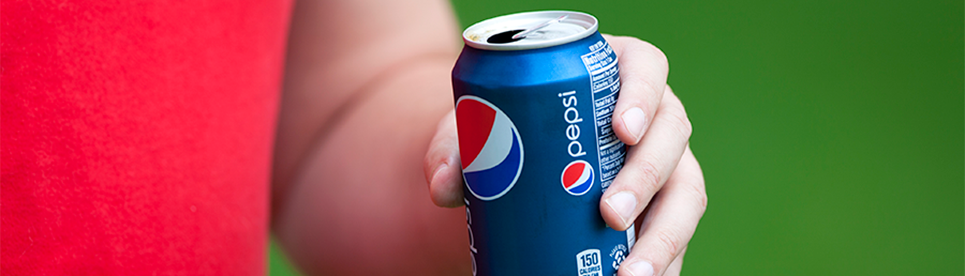 Photo of male student holding a Pepsi can