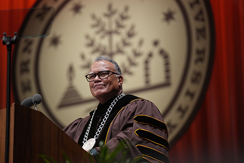 President Edward Montgomery stands at the podium during commencement.
