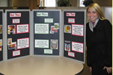 Lindsey next to a bulletin board about Dietetics.