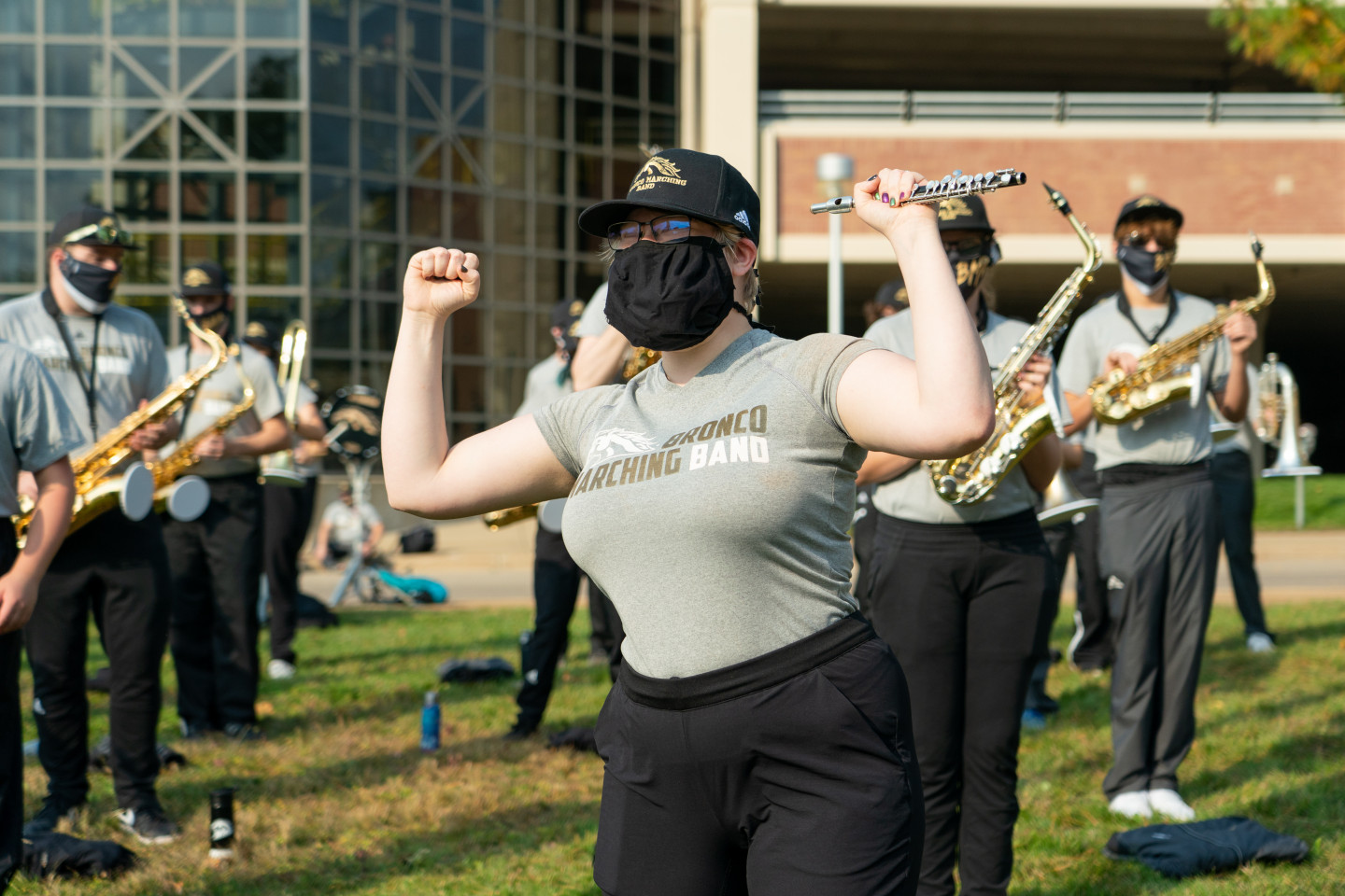 A member of the Bronco Marching Band flexes their muscles.