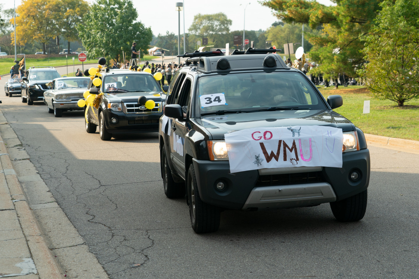 An SUV with a sign that reads, "Go WMU."