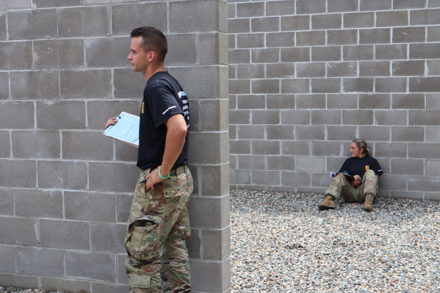 ROTC cadets lean against cement walls.