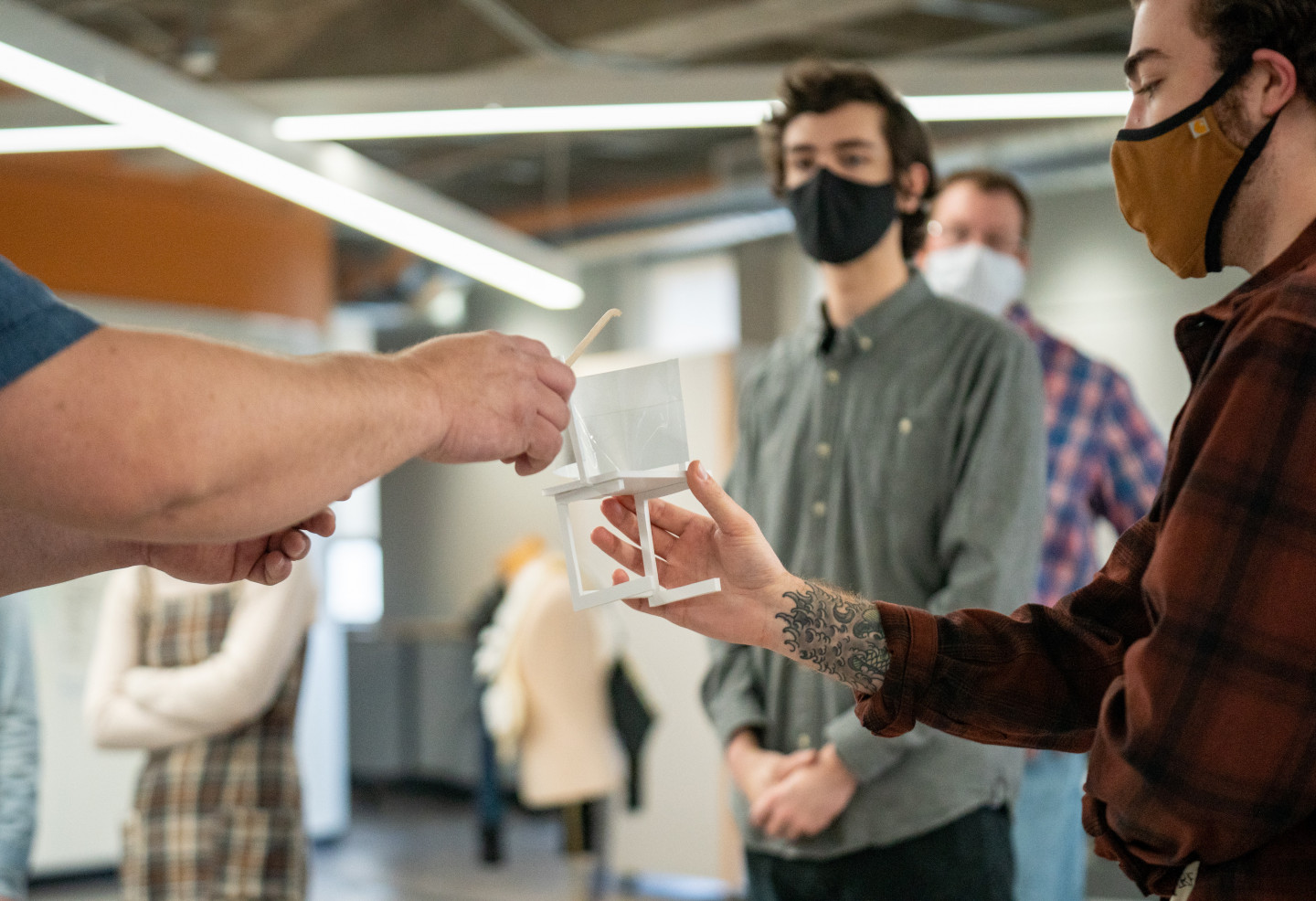 A student holds a prototype of a design.