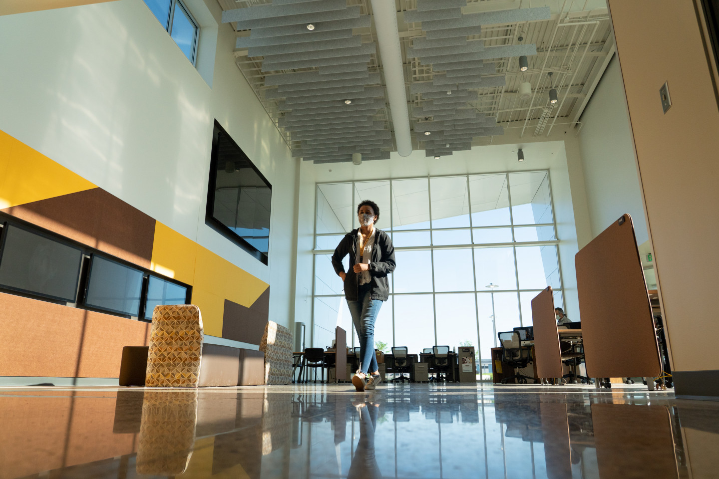 A student walks through the main entrance of the Aviation Education Center.