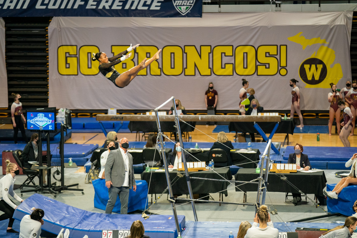 Stacie Harrison performs on the uneven bars.
