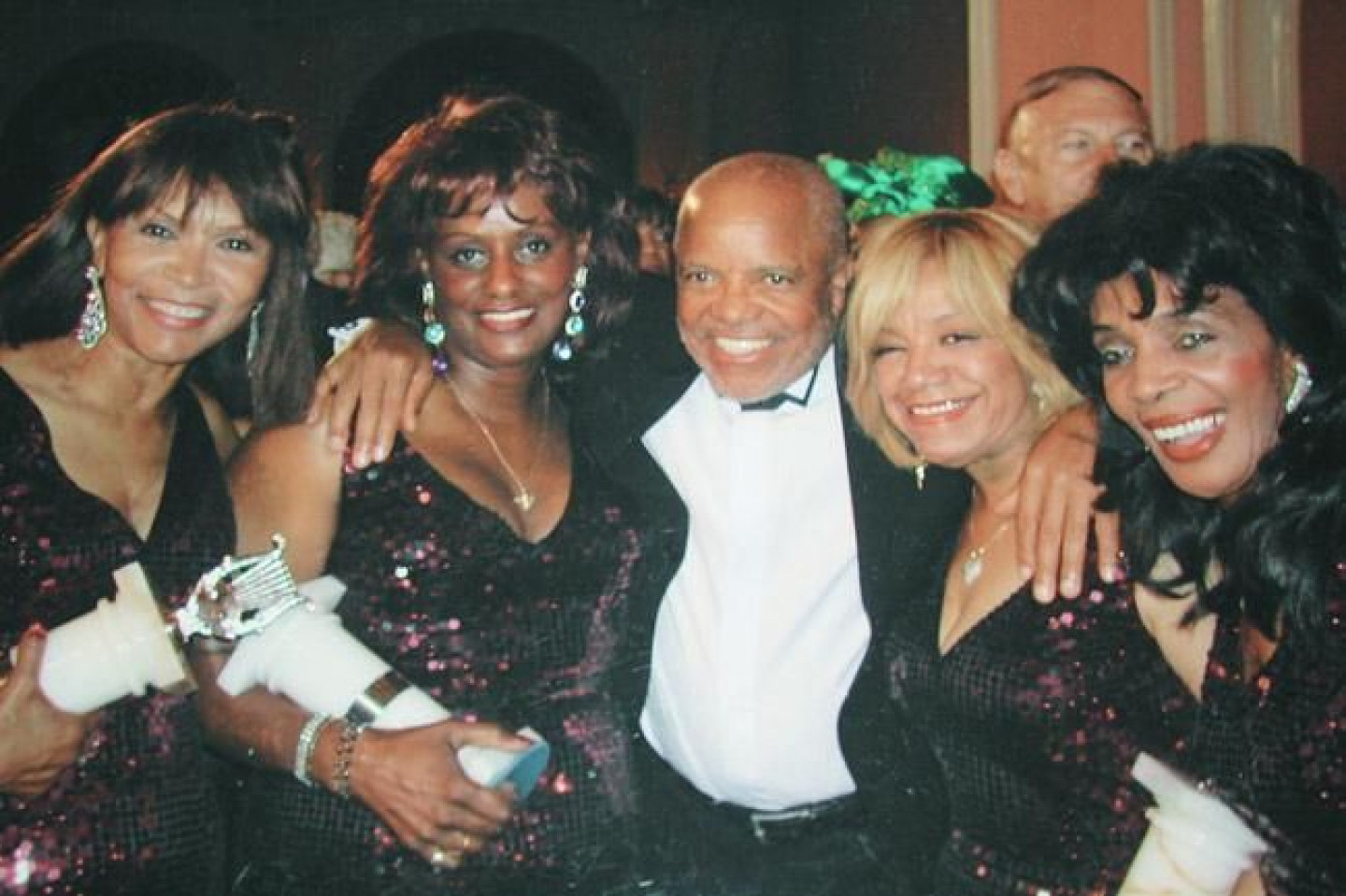 A photo of The Velvelettes with Berry Gordy.