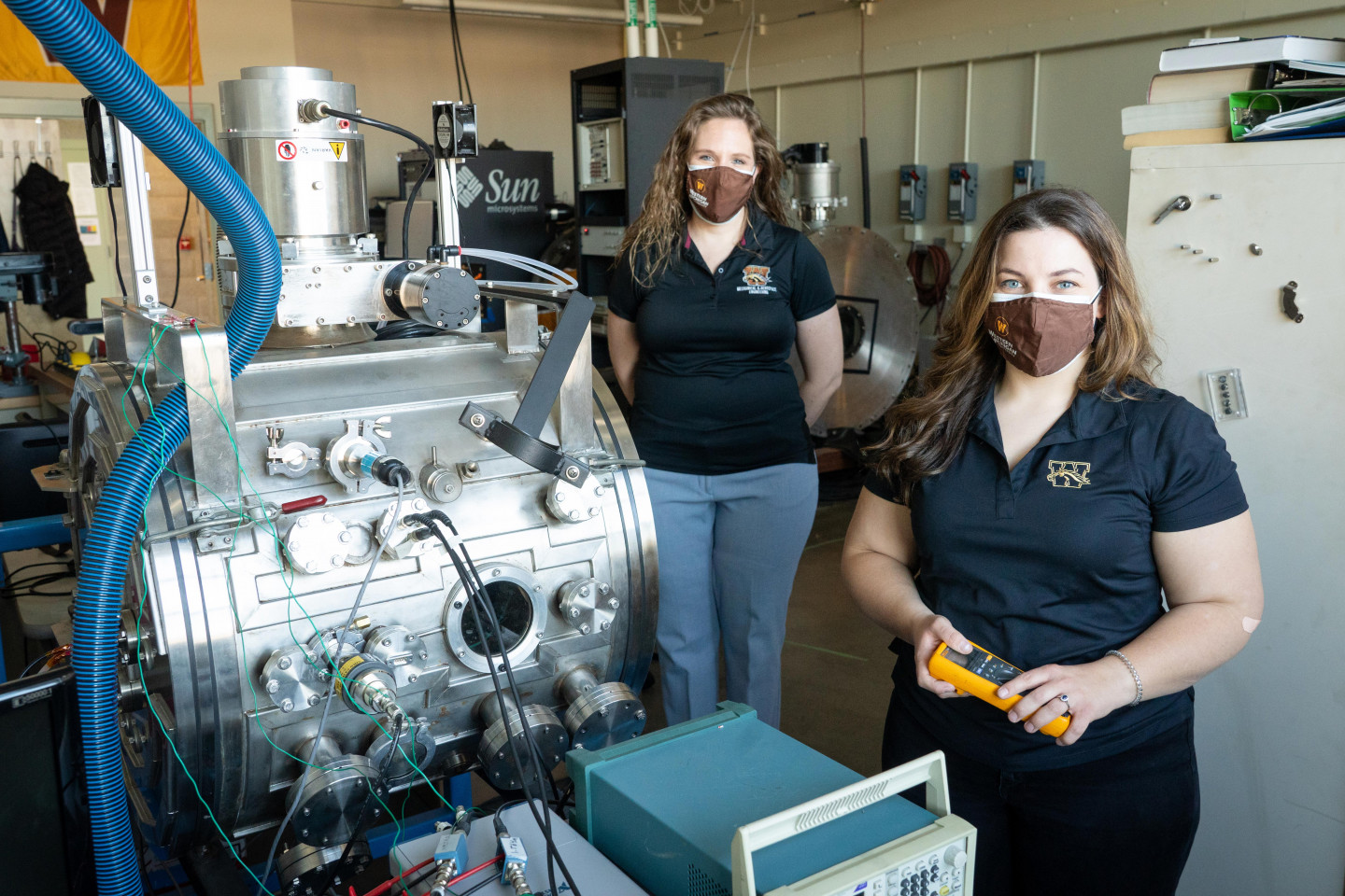Dr. Kristina Lemmer and Margaret Mooney pose for a picture in an engineering laboratory.