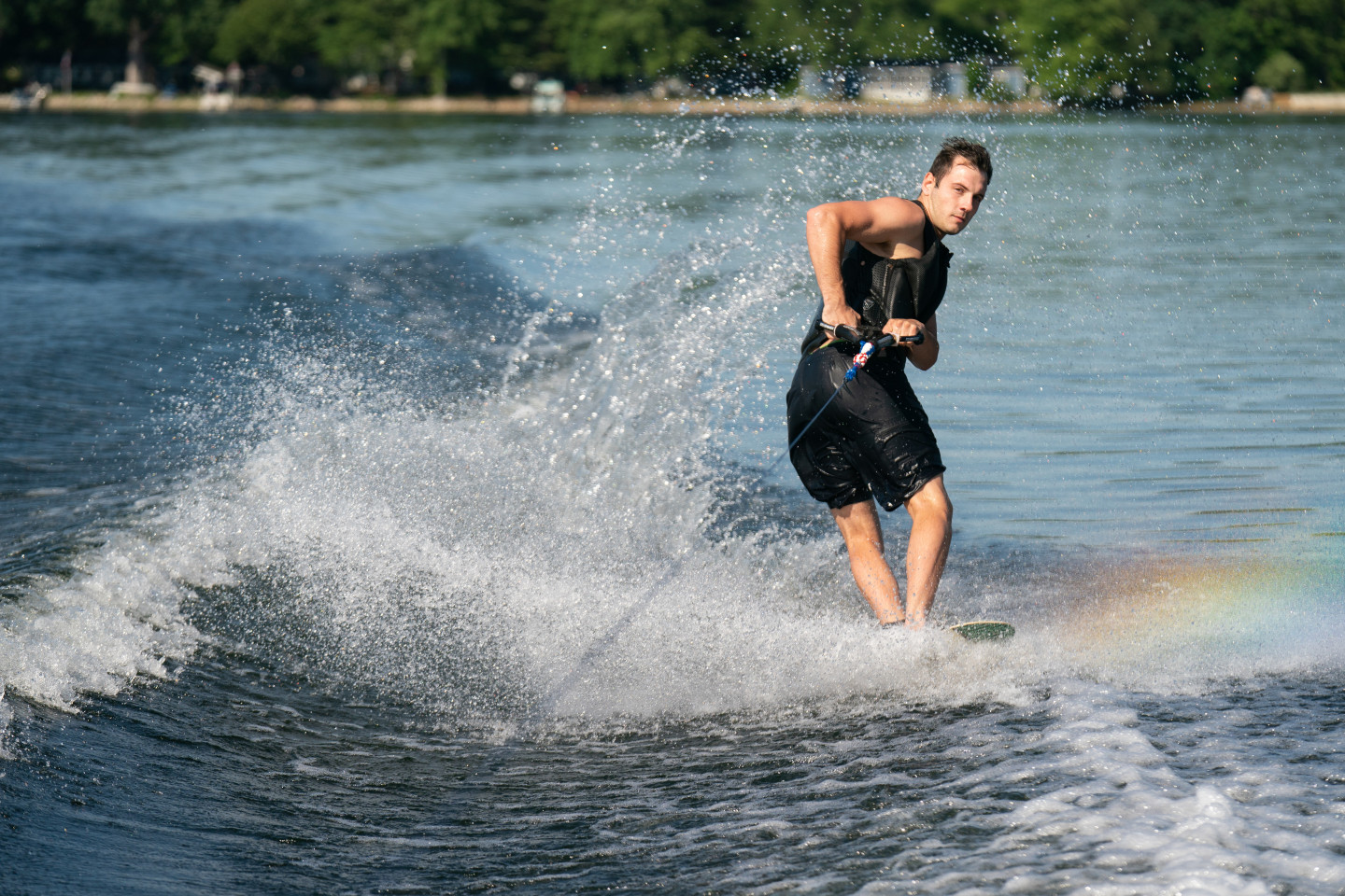 A water skiier spins around on the water.