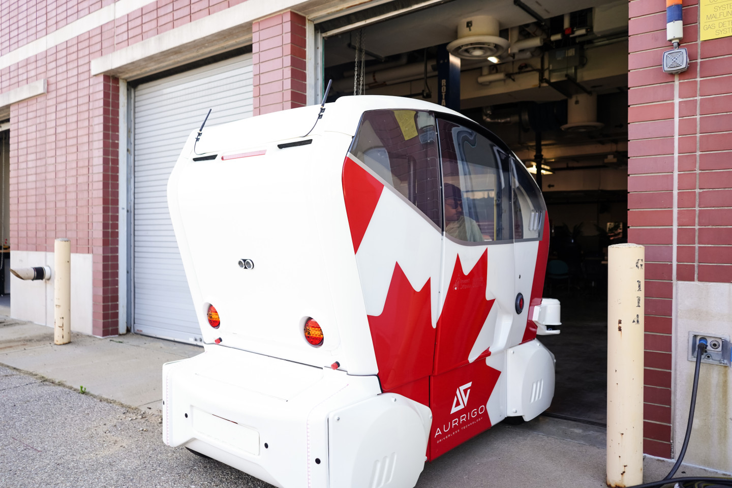 An autonomous vehicle drives through a garage door.