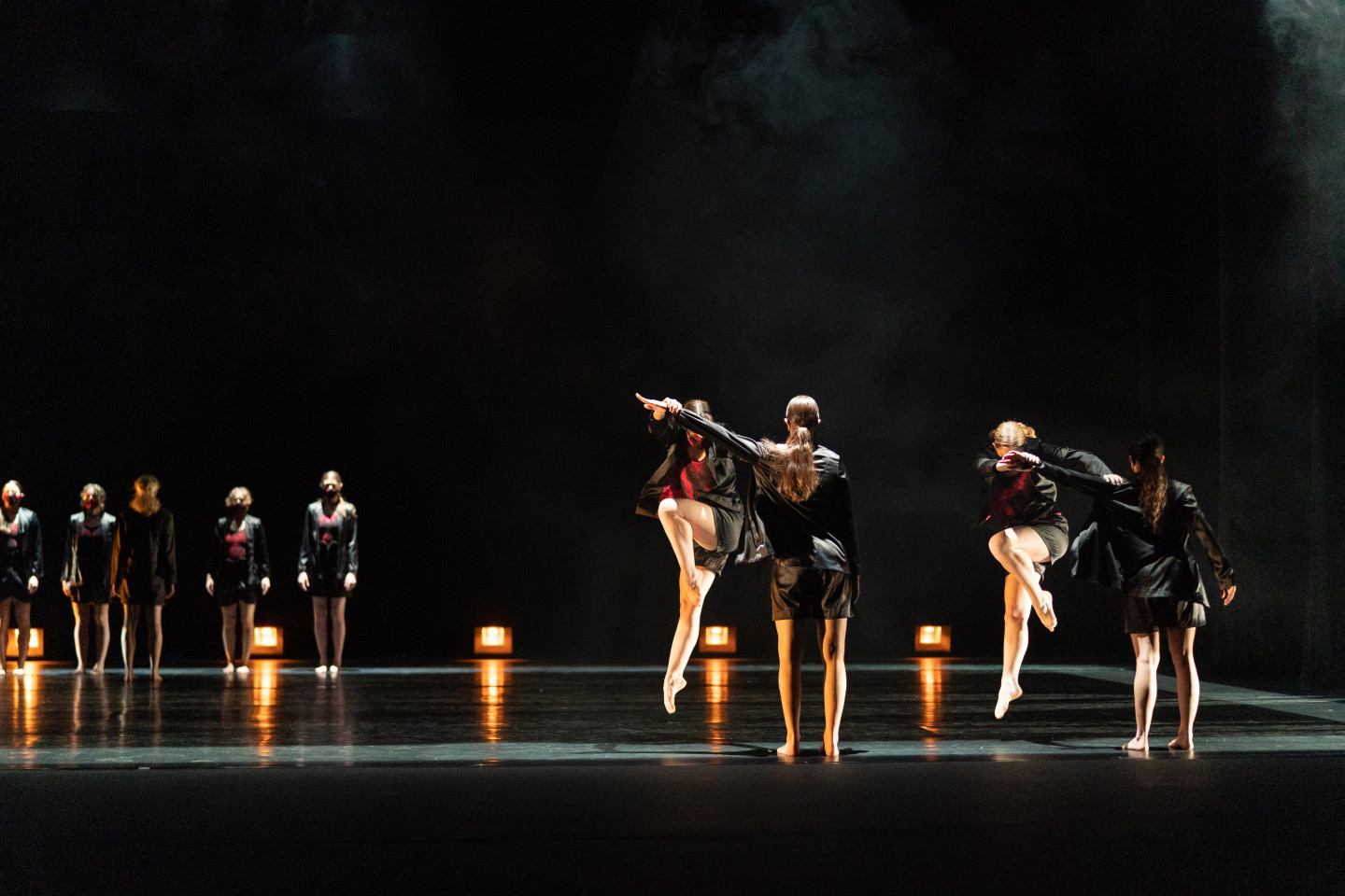 Dancers perform on a stage.