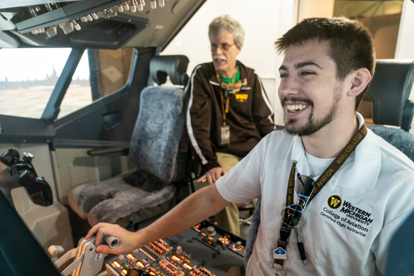 Kyle Albrecht smiles at the controls of an aircraft.