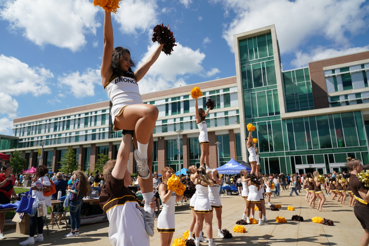 Cheerleaders lead a cheer on campus.