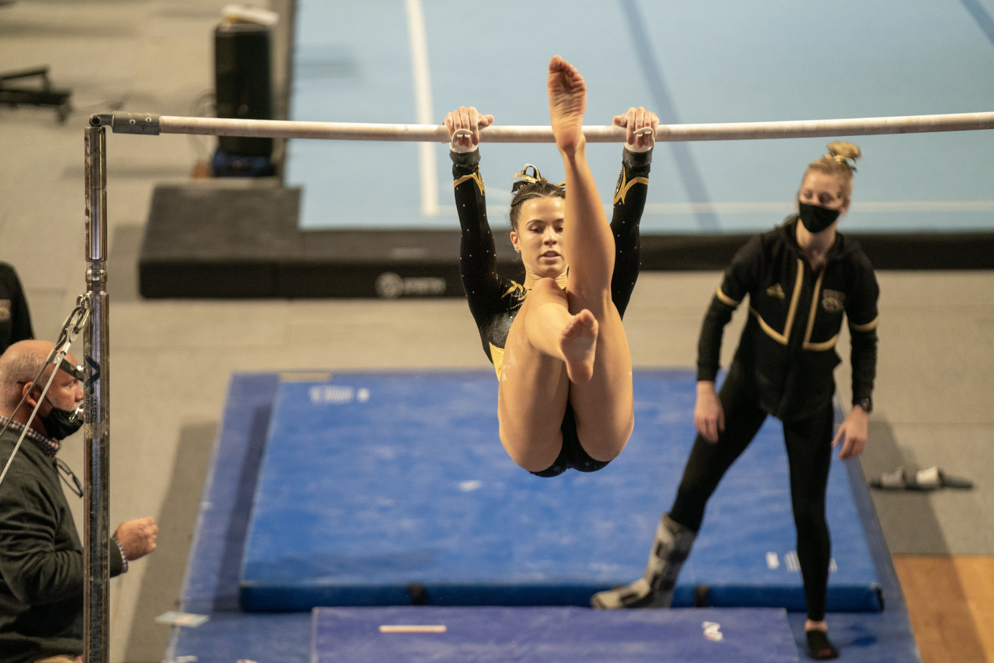 Payton Murphy performs a gymnastics routine on the bars.