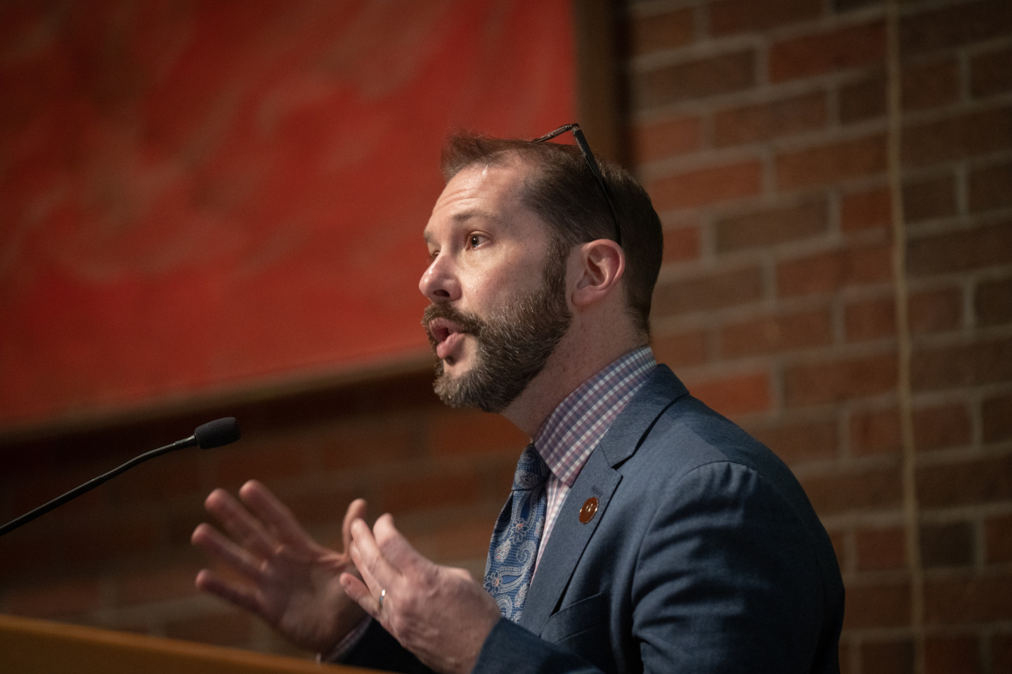 Dr. Edwin Martini talks at a podium.