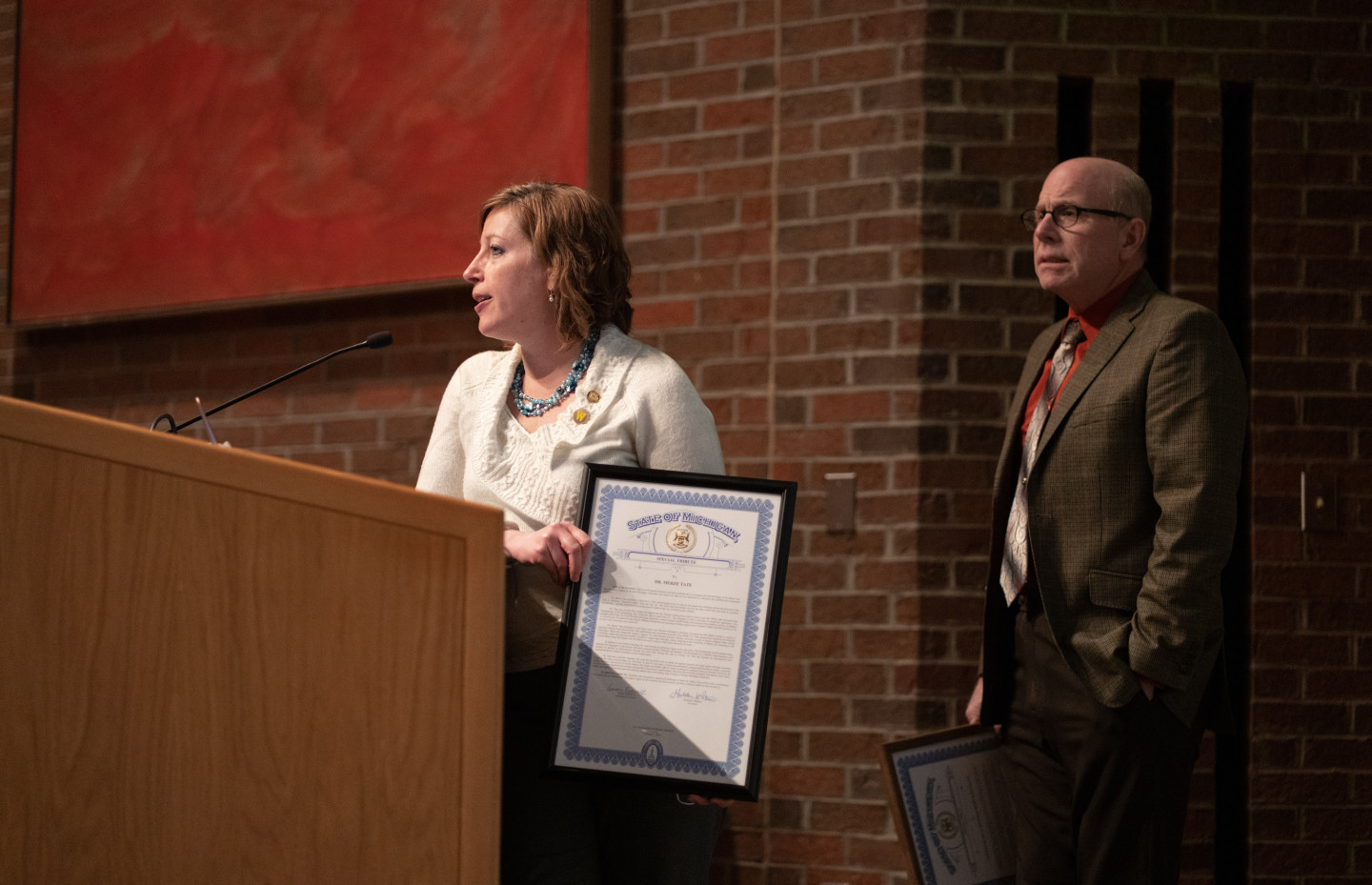 Julie Rogers stands at a podium.