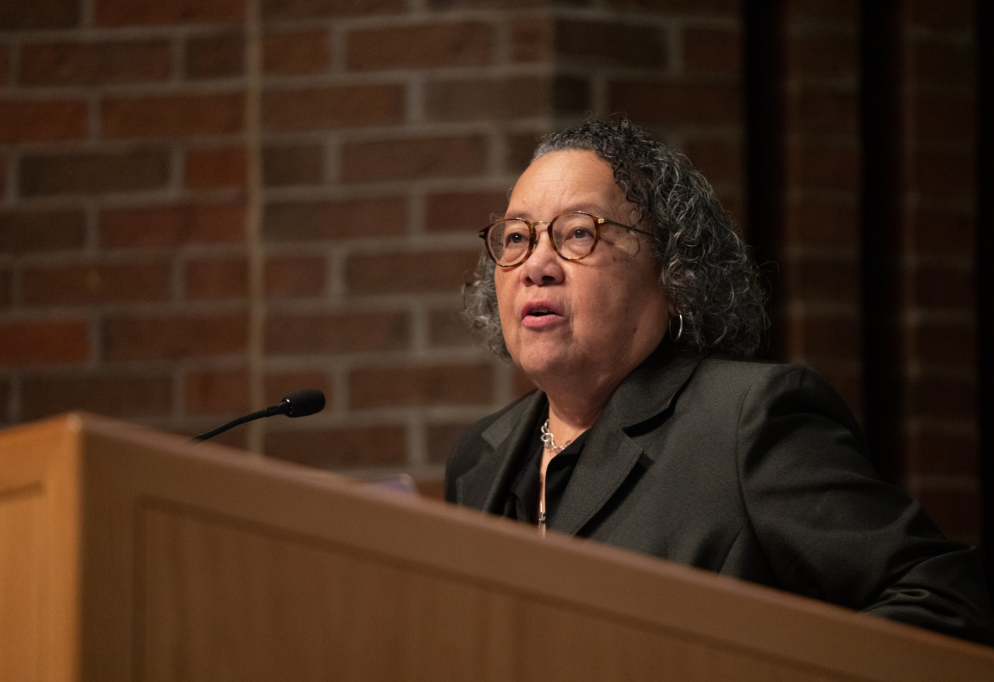 Dr. Barbara Savage speaks at a podium.