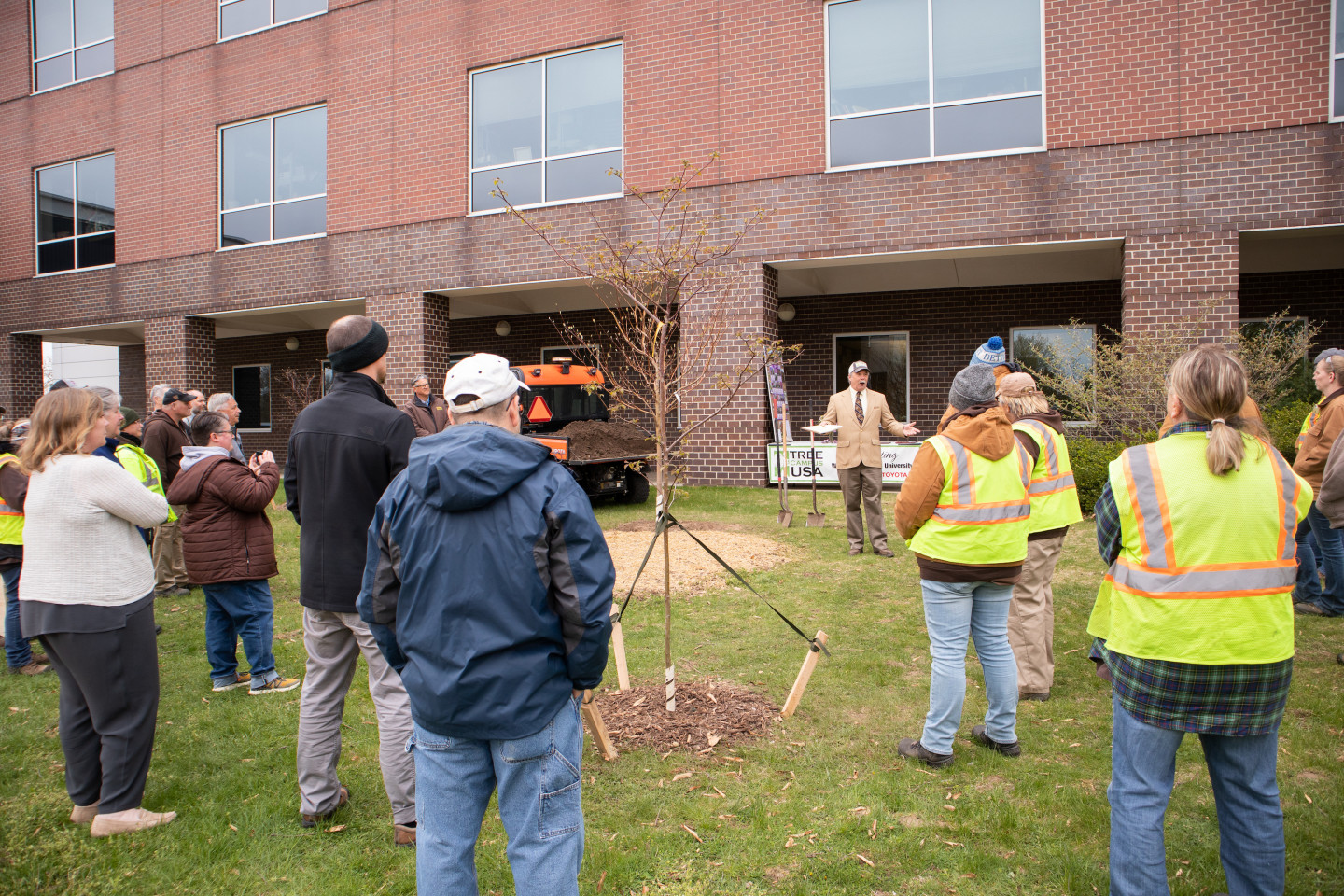 A crowd gathers in front of the Haenicke Hall.