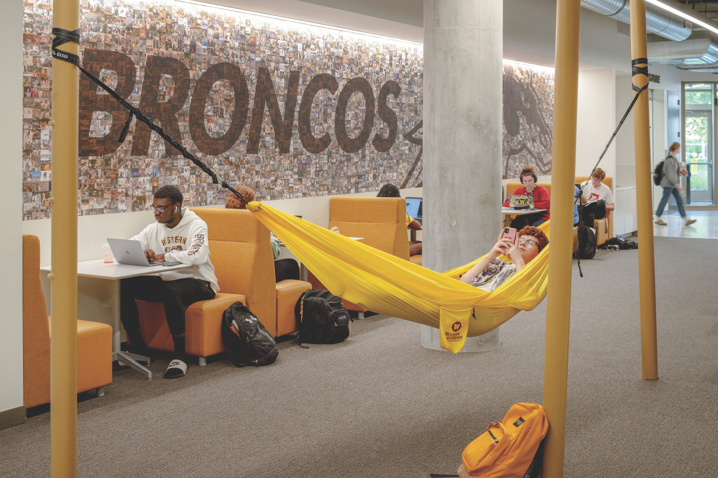 A student relaxes in a yellow hammock.