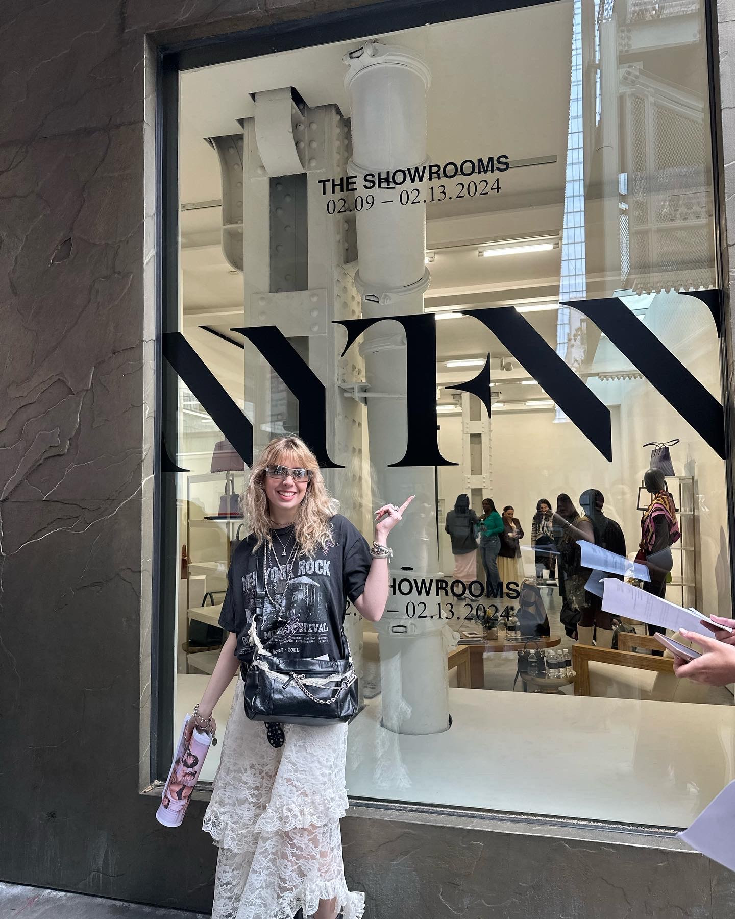 Laura Argentati points to a window with NYFW written on it.