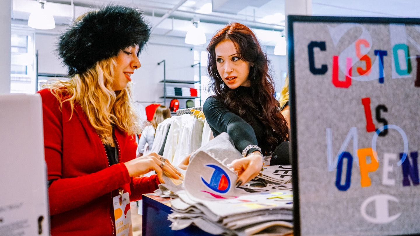 Laura Argentati looks through a book while talking to another student.