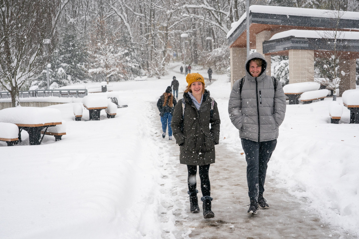 Students walking in the snow on campus.