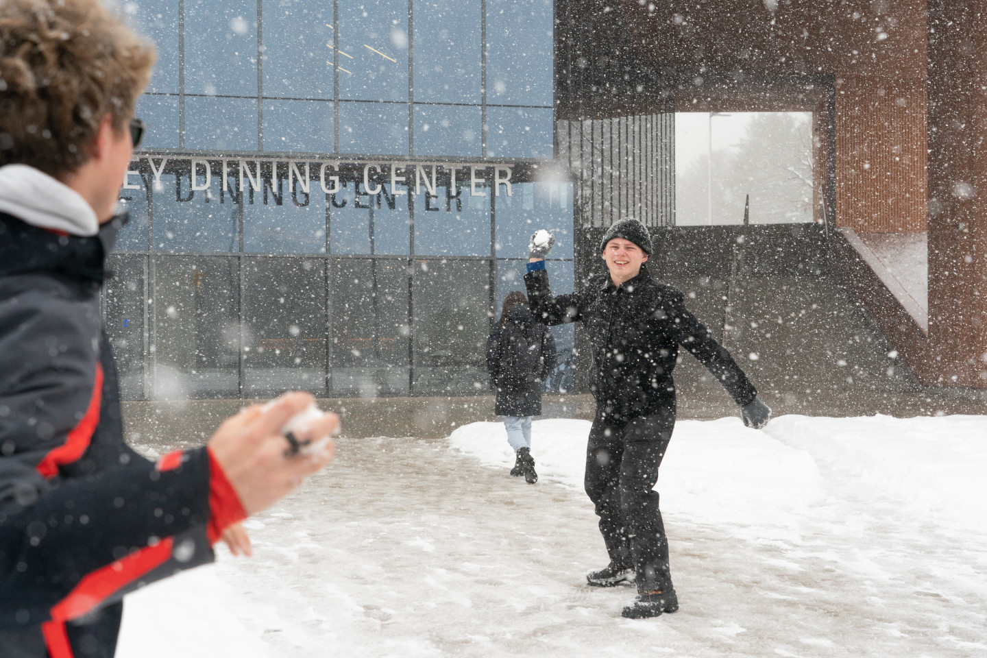 A student throwing a snow ball.