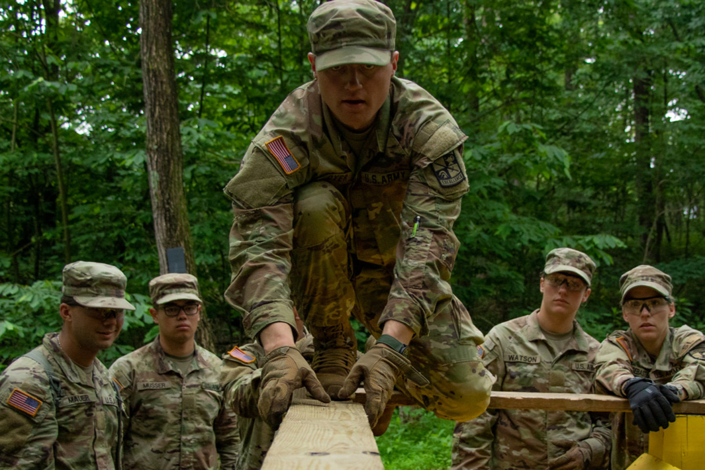 Cadet Cyle Dyer negotiating a balance beam during the obstacle course