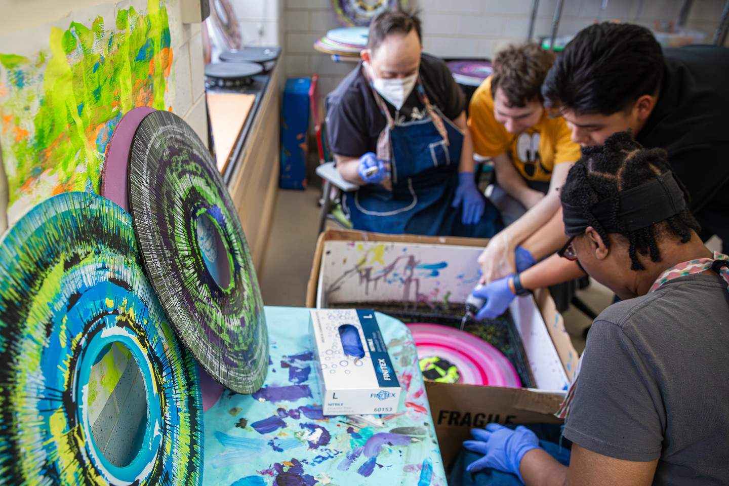 Participants from the Center for Disability Services paint Wild Wheels