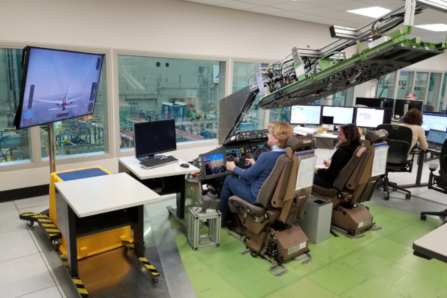 Two test engineers in Boeing lab running simulation