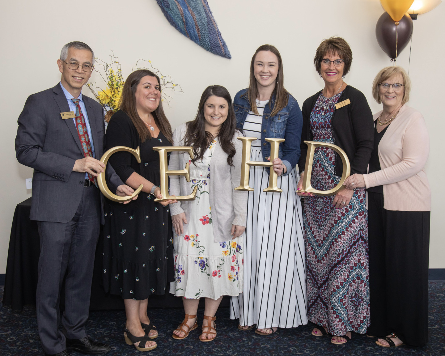 Amy Burns and CEHD staff with former Dean Ming Li at an awards event.