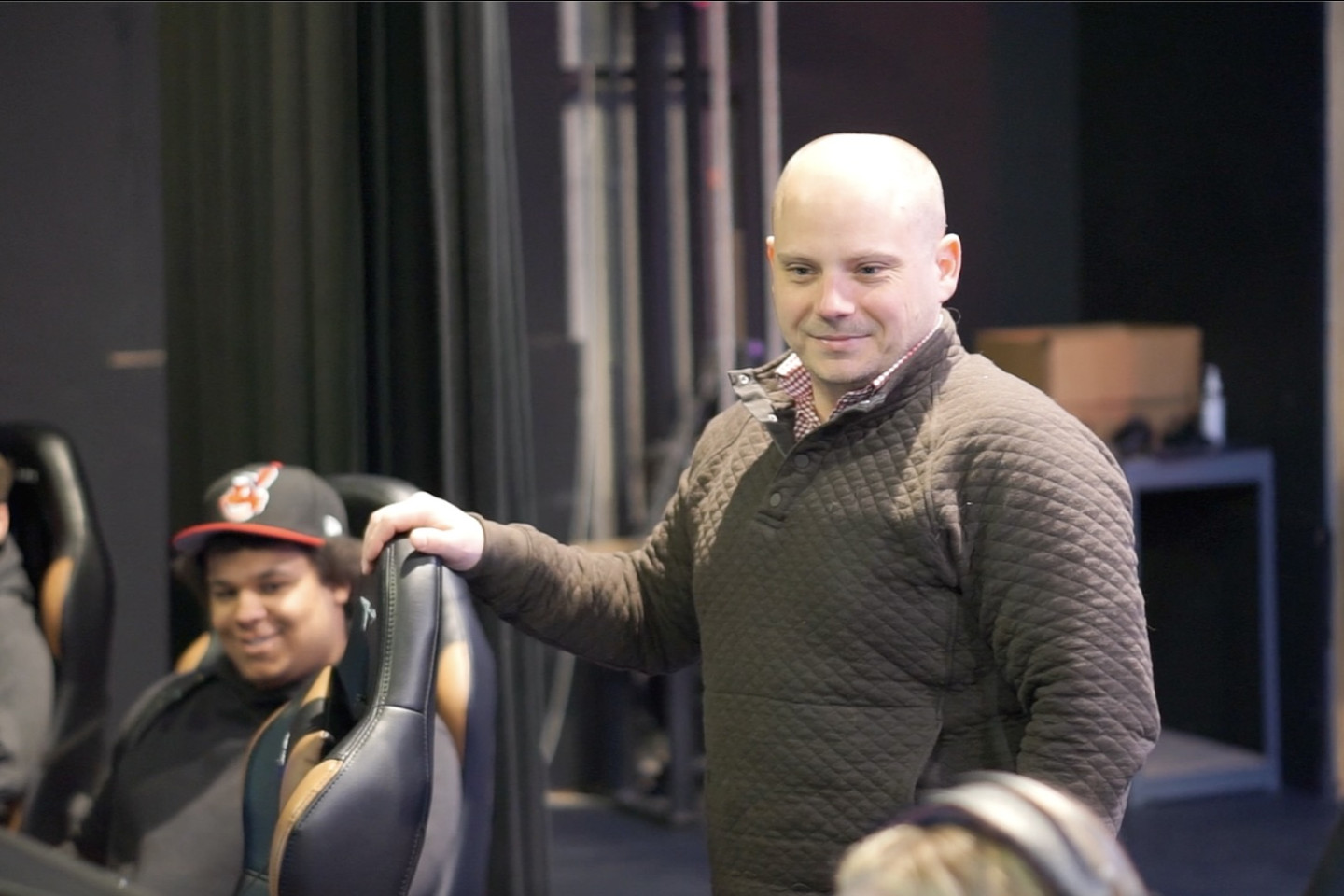 Dr. Collin Cork watching student play video games.