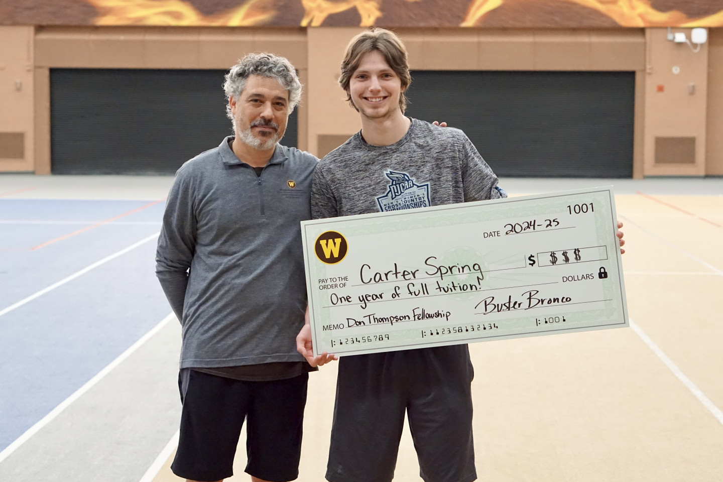 Two men holding check