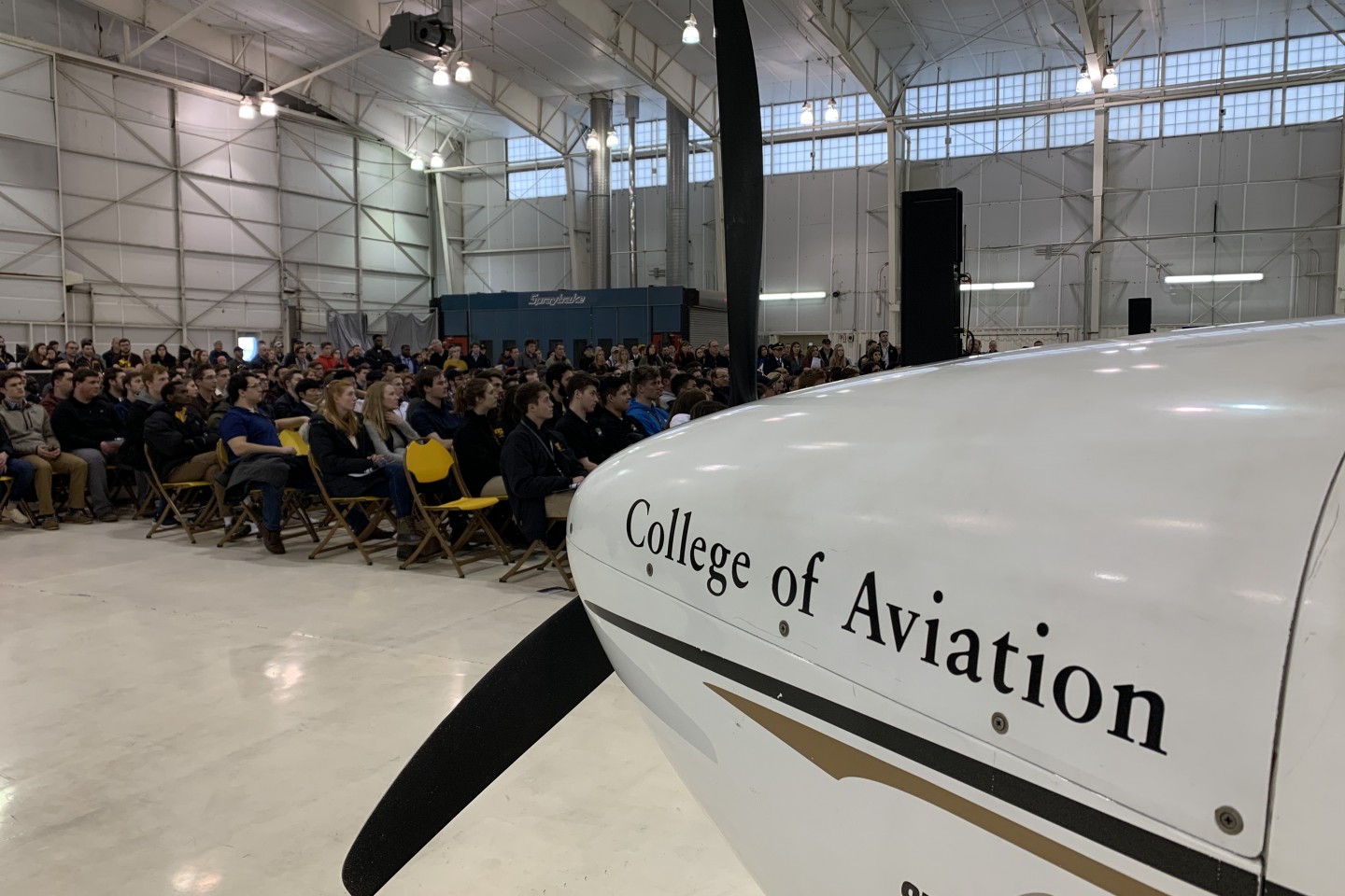 The front of an airplane that reads, "College of Aviation."