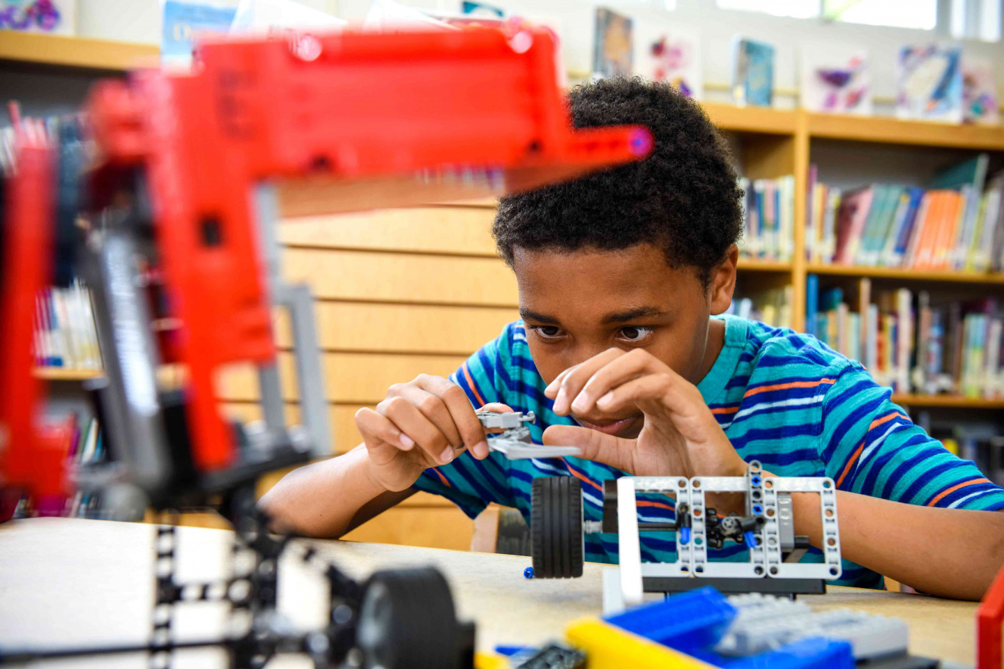 A child works on an engineering project in a classroom.