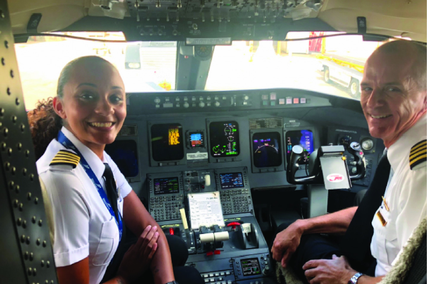 Pilot Alexis Brown sits in the cockpit of a plane.