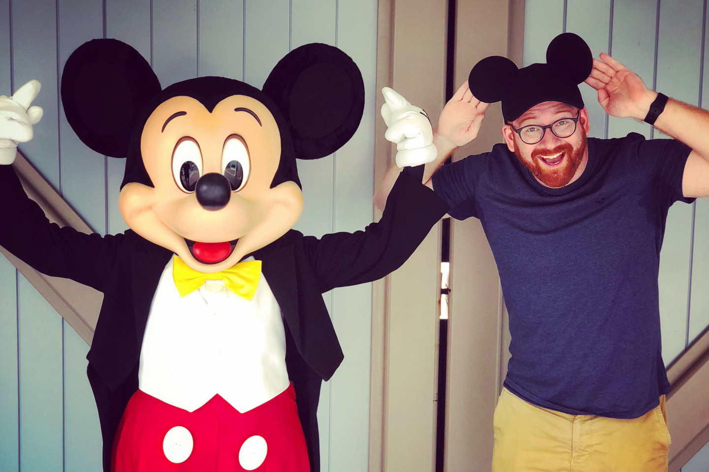 David Alpert poses for a picture with Mickey Mouse.