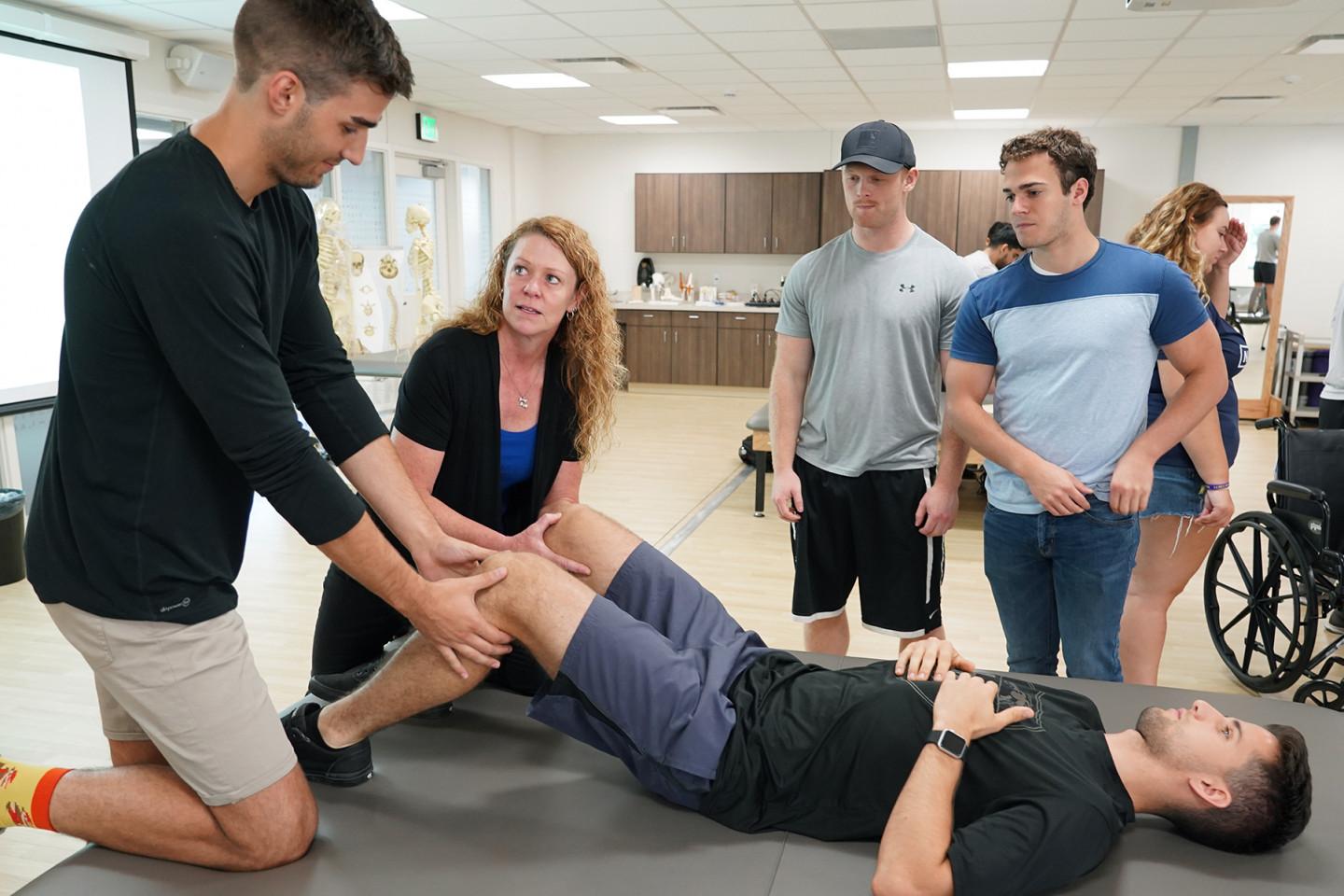 Doctor of Physical Therapy students complete hands-on learning with a patient.