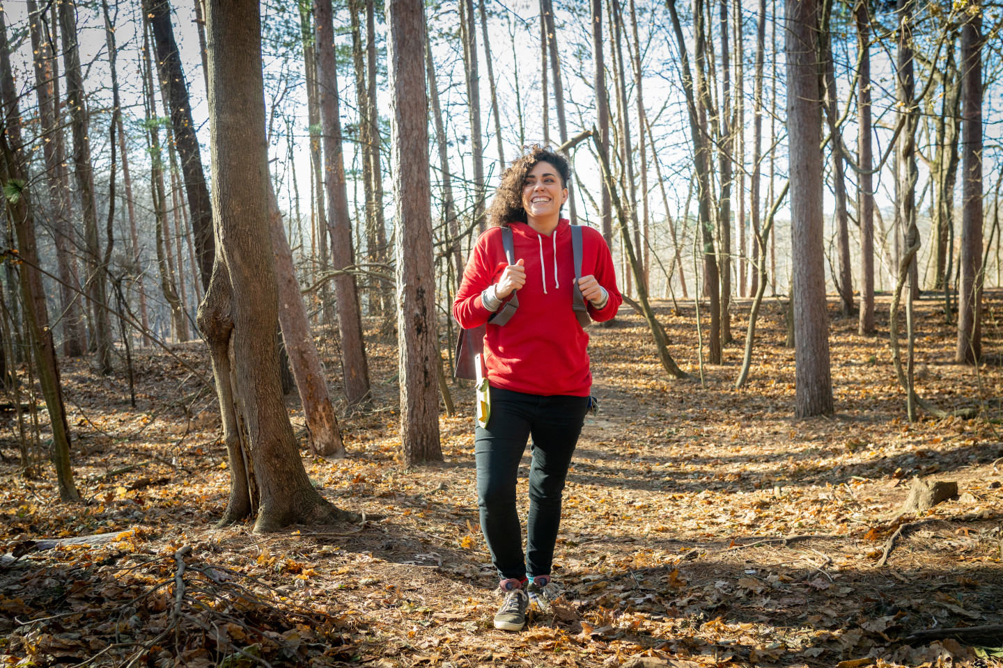 Gabrielle Cerberville stands in a forest.