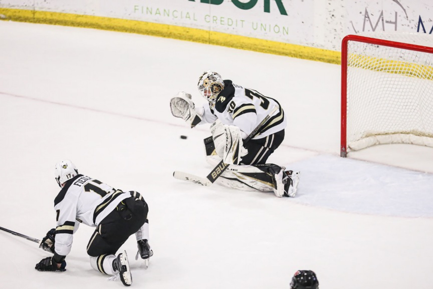 Bronco Hockey goalie Dylan Bussi stops a puck during a hockey game.